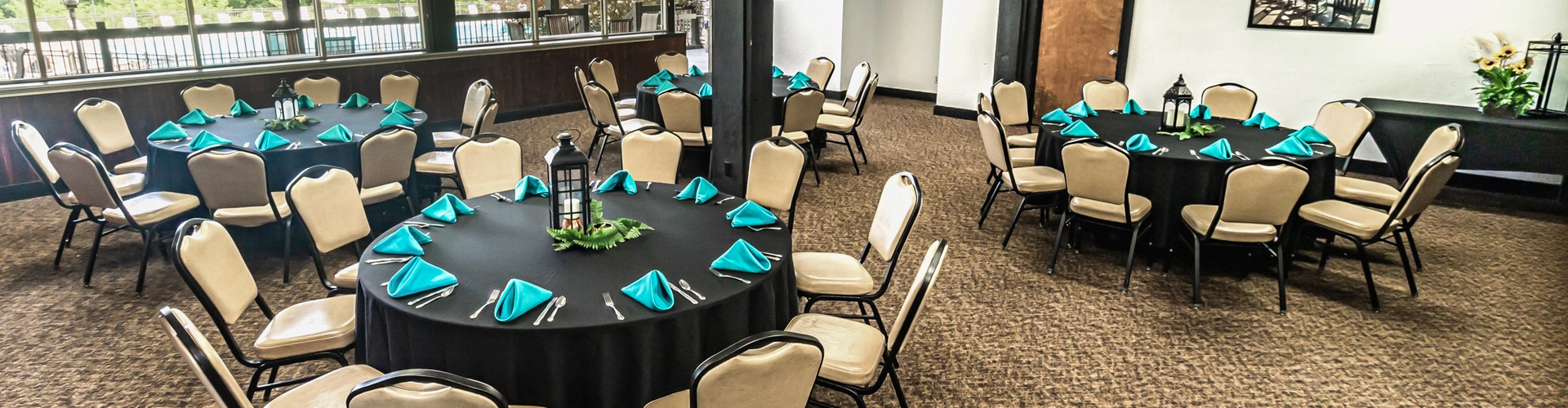 Flexible event space set with round tables and chairs for banquets, receptions, meetings, and group gatherings.